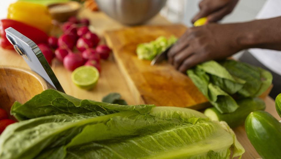 side-view-man-cooking-with-smartphone